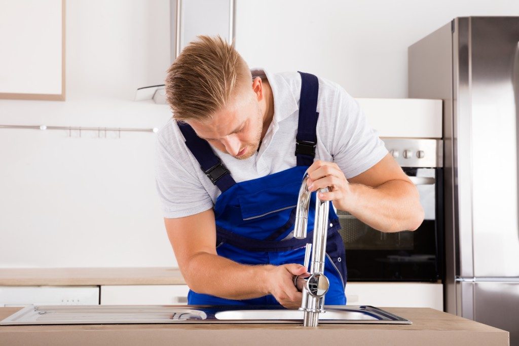 Plumber fixing the sink