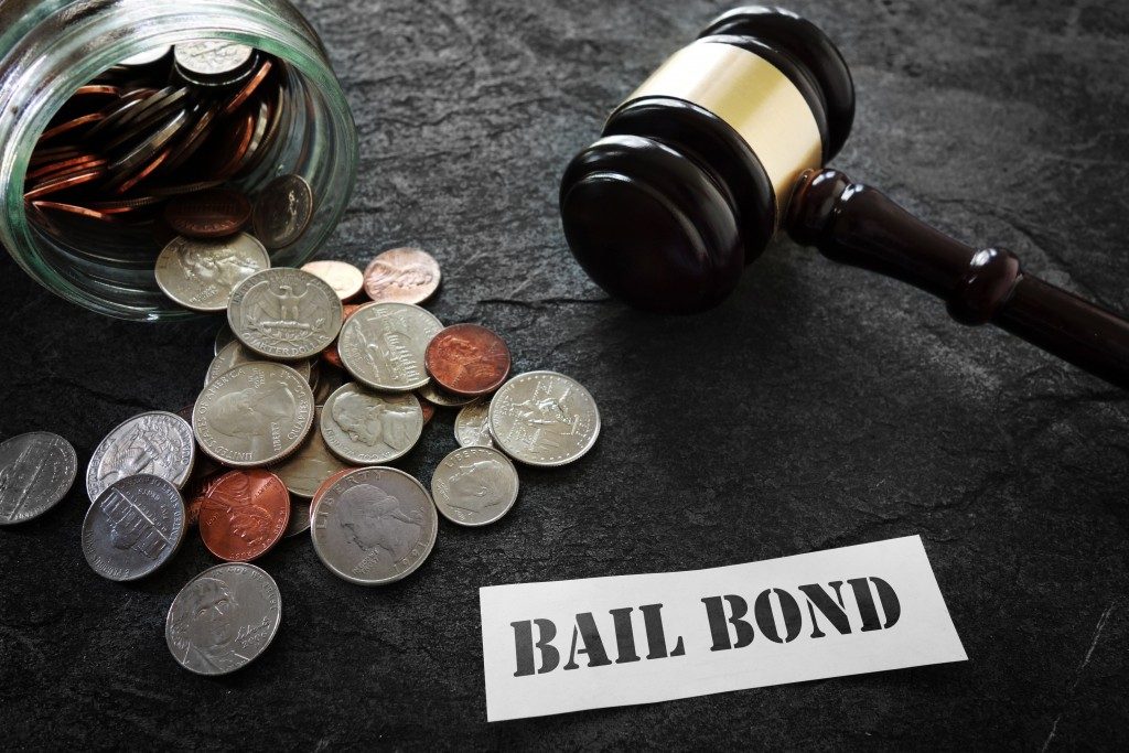 coins gavel and paper with bail bond written
