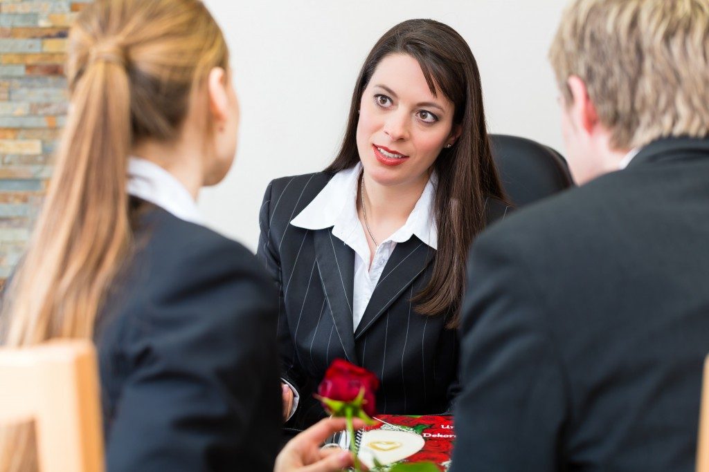 Couple talking to an agent at a funeral home
