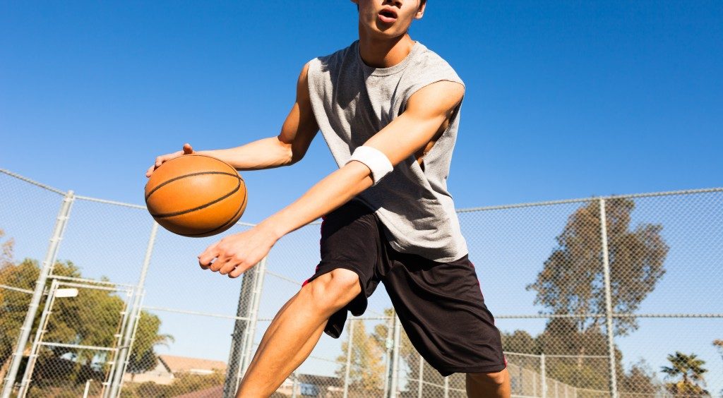 Man playing basketball outdoors