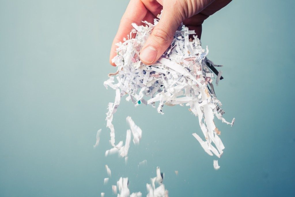 Hand holding shredded paper