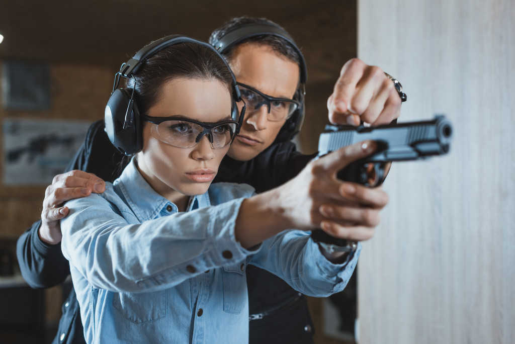 2 people practicing in gun range